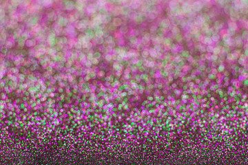 Obraz premium Abstract multicolored glitter background. Green and pink glitter bokeh.
