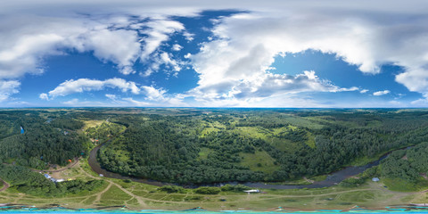 360-degree panoramic aerial view of a field and a meandering river in a green country