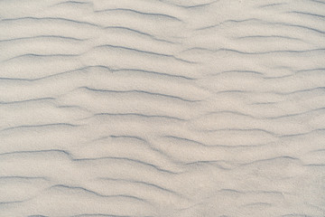 Wellenförmiger Sand als Hintergrund Textur