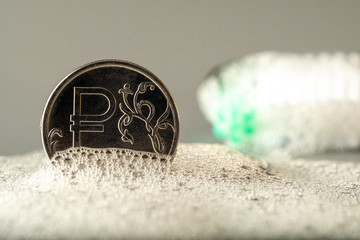 rouble metal coin in the suds. the concept of money laundering