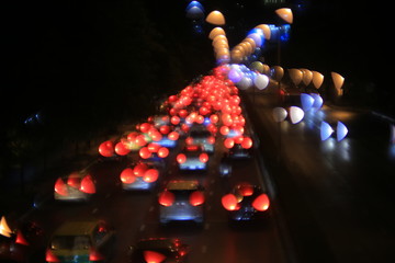 light show on the street. out of focus image of cars traffic jam in the street. high angle view of...