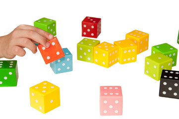 Cubes multi-colored game children's puzzle, the development of logic and team thinking. Children's hands hold colored cubes on a white background.