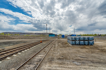 Fototapeta premium The territory of a small industrial warehouse. The warehouse is surrounded by lightning protection masts.