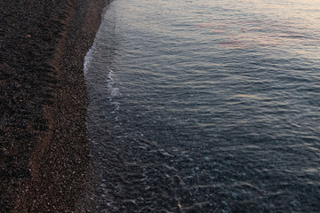 Pebble beach in the early morning light. Close-up. Turkey.