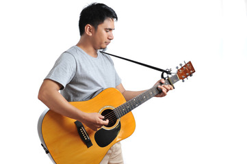 Cheerful handsome young man playing guitar