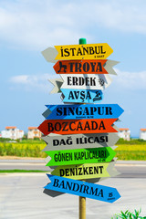 Tourism, travel concept. Colorful road sign pointing directions and distances to different cities...