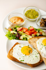 Fried eggs on toasted bread for breakfast