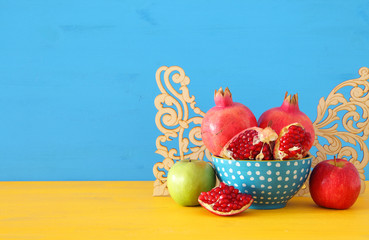rosh hashanah (jewesh holiday) concept -pomegranate and apple traditional holiday symbols