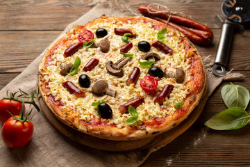 Homemade pizza with sausage and mushrooms