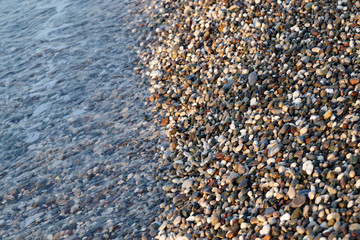 Pebble beach in the early morning light. Close-up. Turkey.