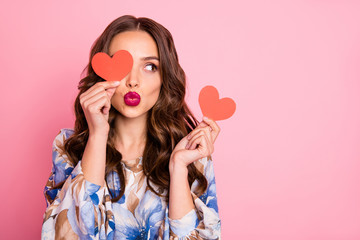 Close-up portrait of her she nice-looking attractive lovely coquettish cheerful cheery wavy-haired girl holding in hands two small little heart sending you kiss isolated over pink pastel background - obrazy, fototapety, plakaty