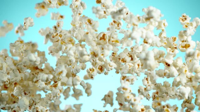 Super slow motion of falling popcorn on coloured background. Filmed on high speed cinema camera, 1000fps.