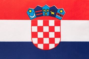 Croatia national fabric flag, textile background. Symbol of international world european country.