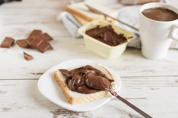Delicious toast bread with chocolate paste on plate closeup. Sweet breakfast.