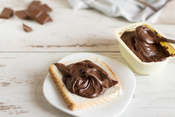 Delicious toast bread with chocolate paste on plate closeup. Sweet breakfast.
