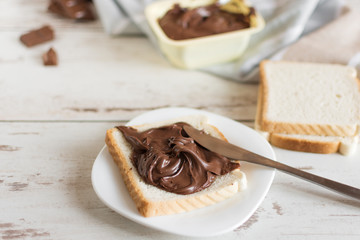 Delicious toast bread with chocolate paste on plate closeup. Sweet breakfast.