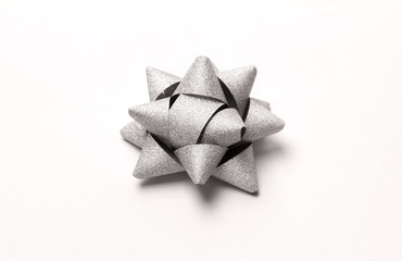 Silver glitter gift bow isolated on white.