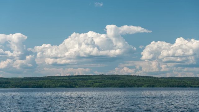 Time lapse video of clouds over lake Pielinen at sunny summer day in Nurmes, Finland