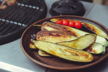 The chef cooks vegetables on the grill. Golden, juicy and appetizing grilled vegetables, delicious food group plan
