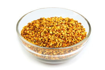 Bee pollen grains in glass bowl isolated.