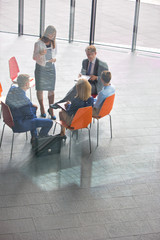 High angle view of colleagues planning while sitting during meeting at office