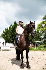 Horse riding. The woman rider rides a horse.