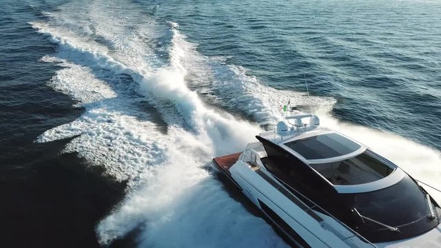 Aerial view of a luxury yacht navigating fast.