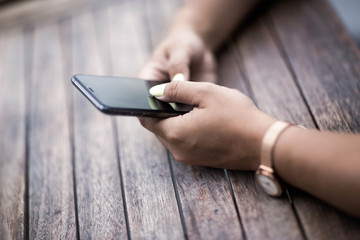Close up of hands woman using her cell phone. Outdoor.