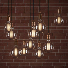 Decorative vintage light bulbs in edison style on brick wall background. 3D rendering.