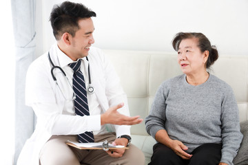 Asian young Doctor talking with Senior woman in hospital