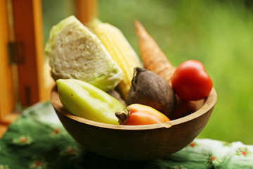 fresh vegetables from garden - carrot, kale,corn,paprika,beetroot, potato in wooden bowl close up photo