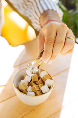 Top view of sugar being added to the coffee