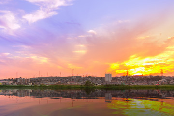 Obraz premium Sunset over village with reflection view.