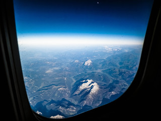 View from plane window on Planet Earth, Alps Mountains.