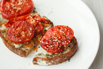 Tasty and healthy.Sandwich with cream cheese and tomatoes for Breakfast.