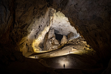 Cavers progressing towards the Great Wall of Vietnam in Son Doong cave, Vietnam
