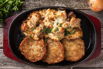 Potato pancakes with meat and sour cream. Machanka. Top view. Traditional  Belarusian cuisine