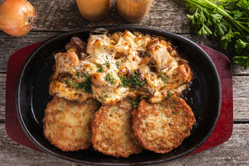 Potato pancakes with meat and sour cream. Machanka. Traditional  Belarusian cuisine