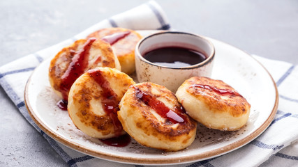 Cottage cheese pancakes with strawberry sauce on a plate. Healthy breakfast