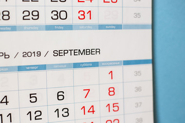 Close-up calendar for the month of September 2019. Hello September. Hello, Autumn. Russian-English calendar on a blue background