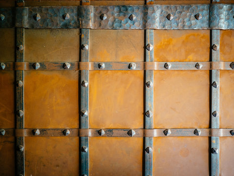 Metal door covered with rust. Square shapes