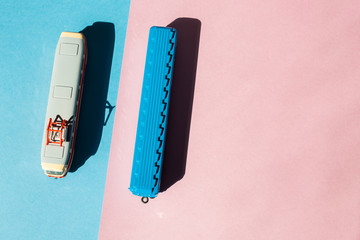 Models of a Russian metro car and tram on a pink background with sunlight. Russian transport. Toy models