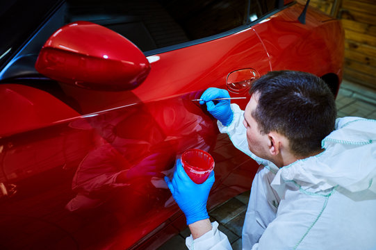 Tinting defects of a red car paint on the service