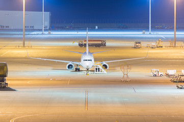 Night view of airport with aircraft.