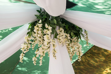 Getting ready for the wedding ceremony. Decor of white wisteria closeup
