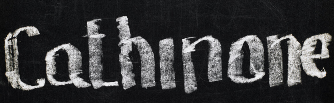panoramic shot of black chalk board with lettering cathinone