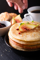 Food concept Homemade organic pancakes stack with fig breakfast on black background