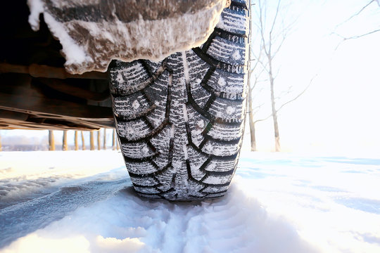 winter tires with spikes on the snow / transport road northern wheels, climate winter season