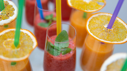 Close-up of cocktail with tropical fruit in wineglass. Fresh exotic juice like a concept of summer, travel