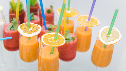 Close-up of cocktail with tropical fruit in wineglass. Fresh exotic juice like a concept of summer, travel